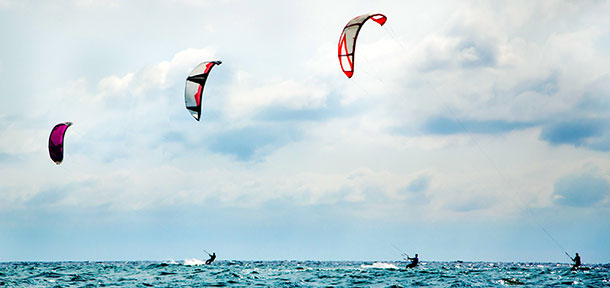 three-kitesurfers